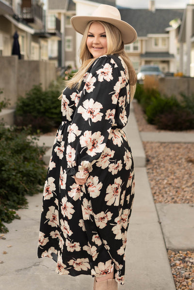 Side view of a plus size black floral maxi dress