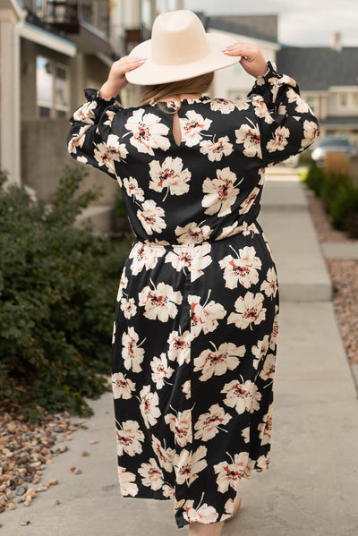 Back view of a plus size black floral maxi dress