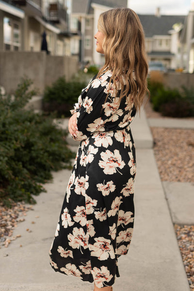 Side view of a black floral maxi dress