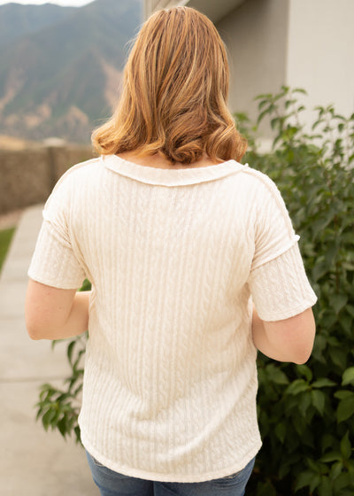 Back view of a short sleeve cream top