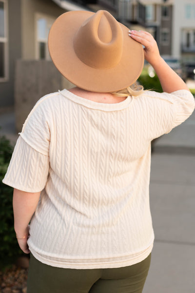 Back view of a plus size cream top