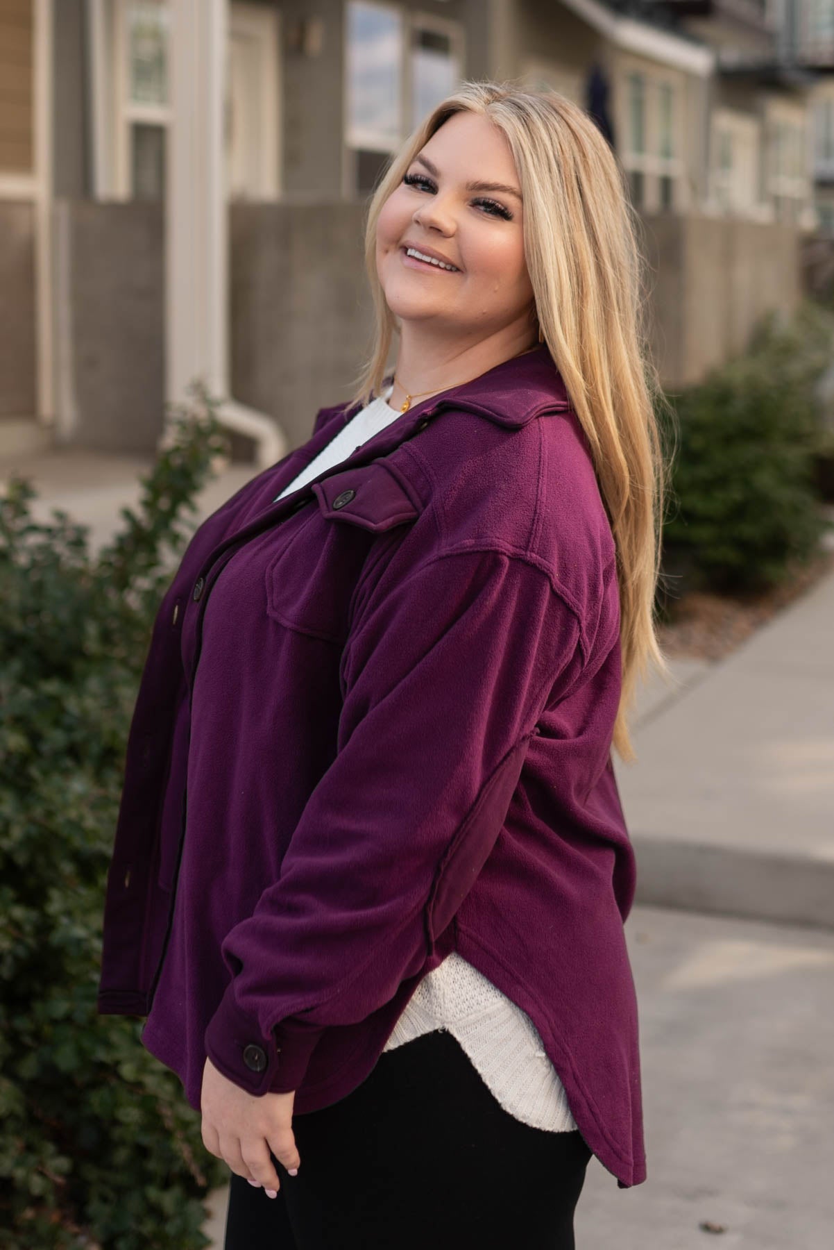Side view of a plus size dark plum shacket