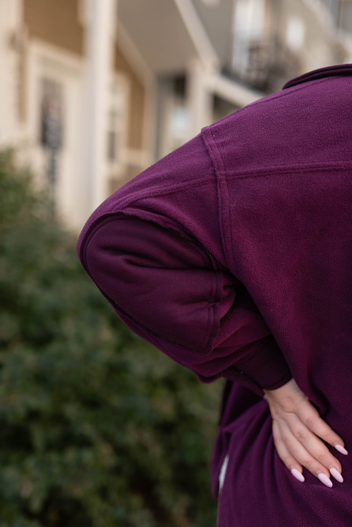 Close up view of a plus size dark plum shacket