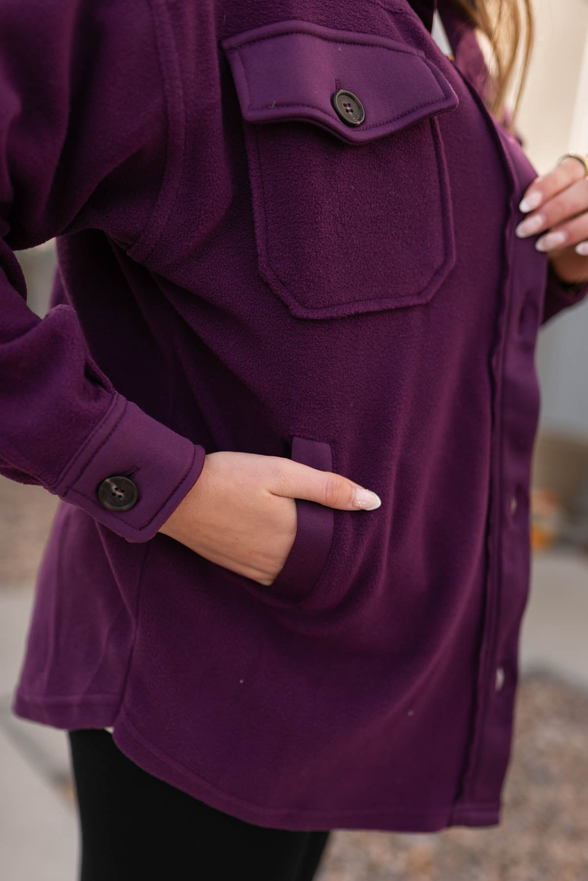 Side pockets in a dark plum shacket