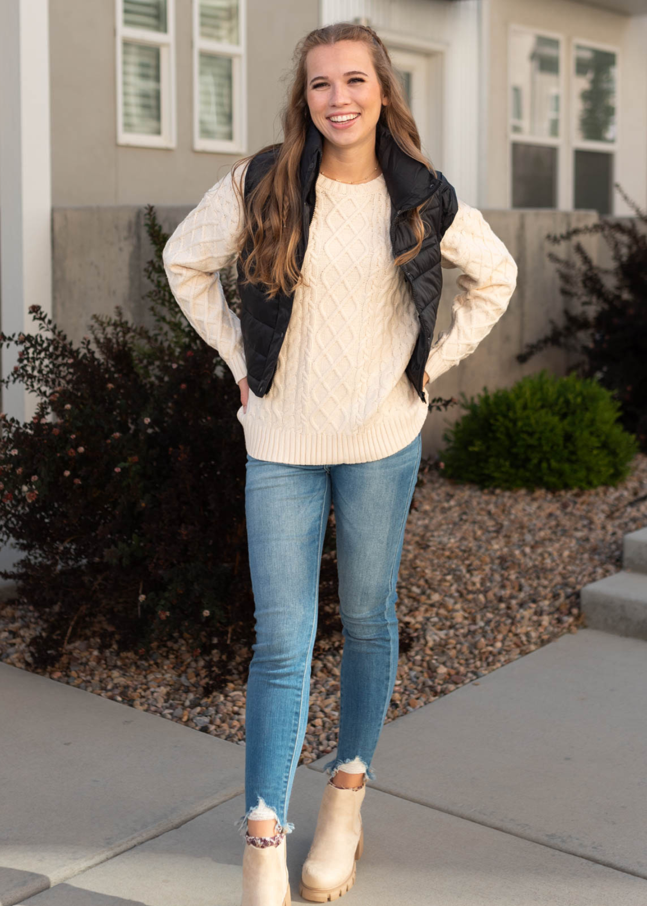 Oatmeal sweater with a black vest that is sold separately