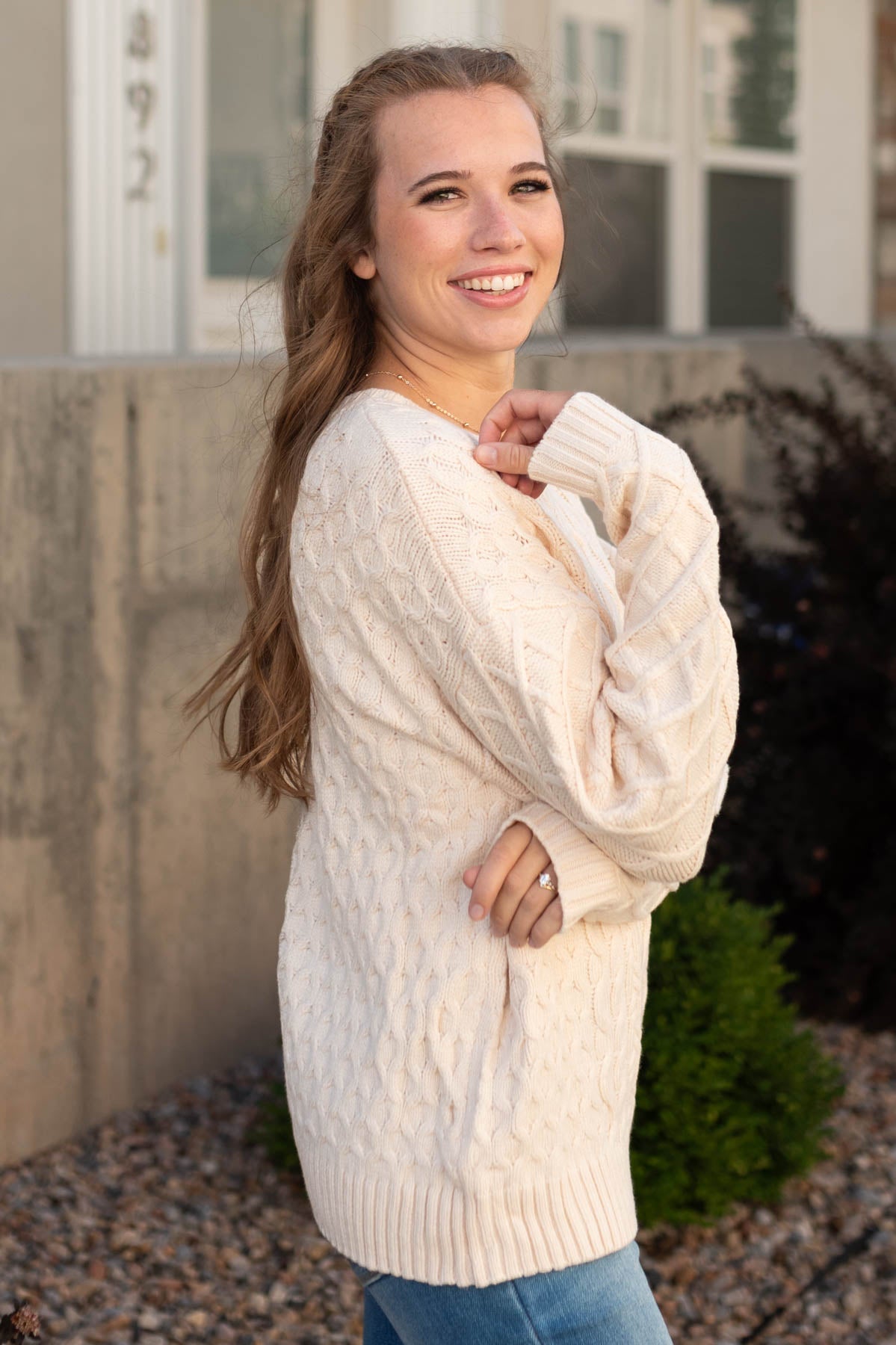 Side view of a oatmeal sweater