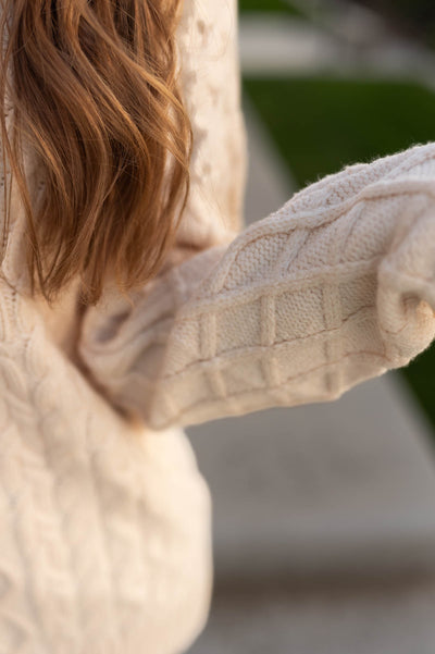 Sweater pattern on an oatmeal sweater