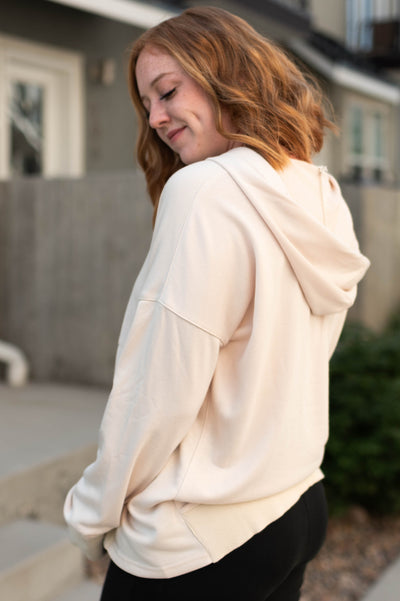 Side view of a oatmeal hoodie