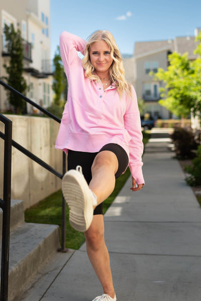 Long sleeve pink hoodie with snaps at the neck