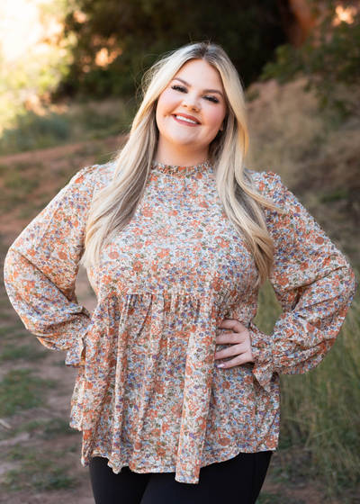 Plus size long sleeve rust floral top with ruffle at the neck