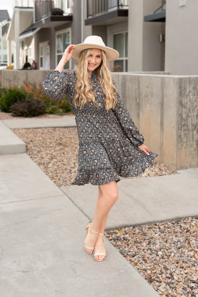 Long sleeve navy pattern dress with a tiered skirt