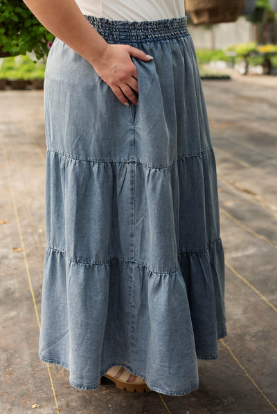Side view of the denim blue skirt with pockets