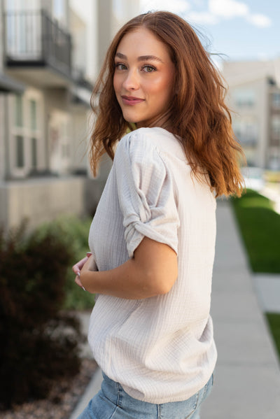 Side view of a short sleeve grey top