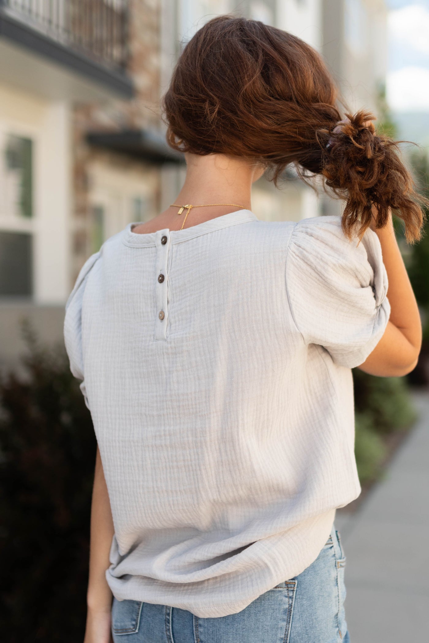 Back view of a short sleeve grey top