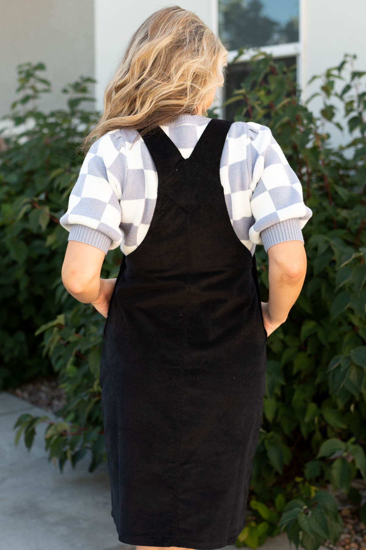Back view of a overall black dress