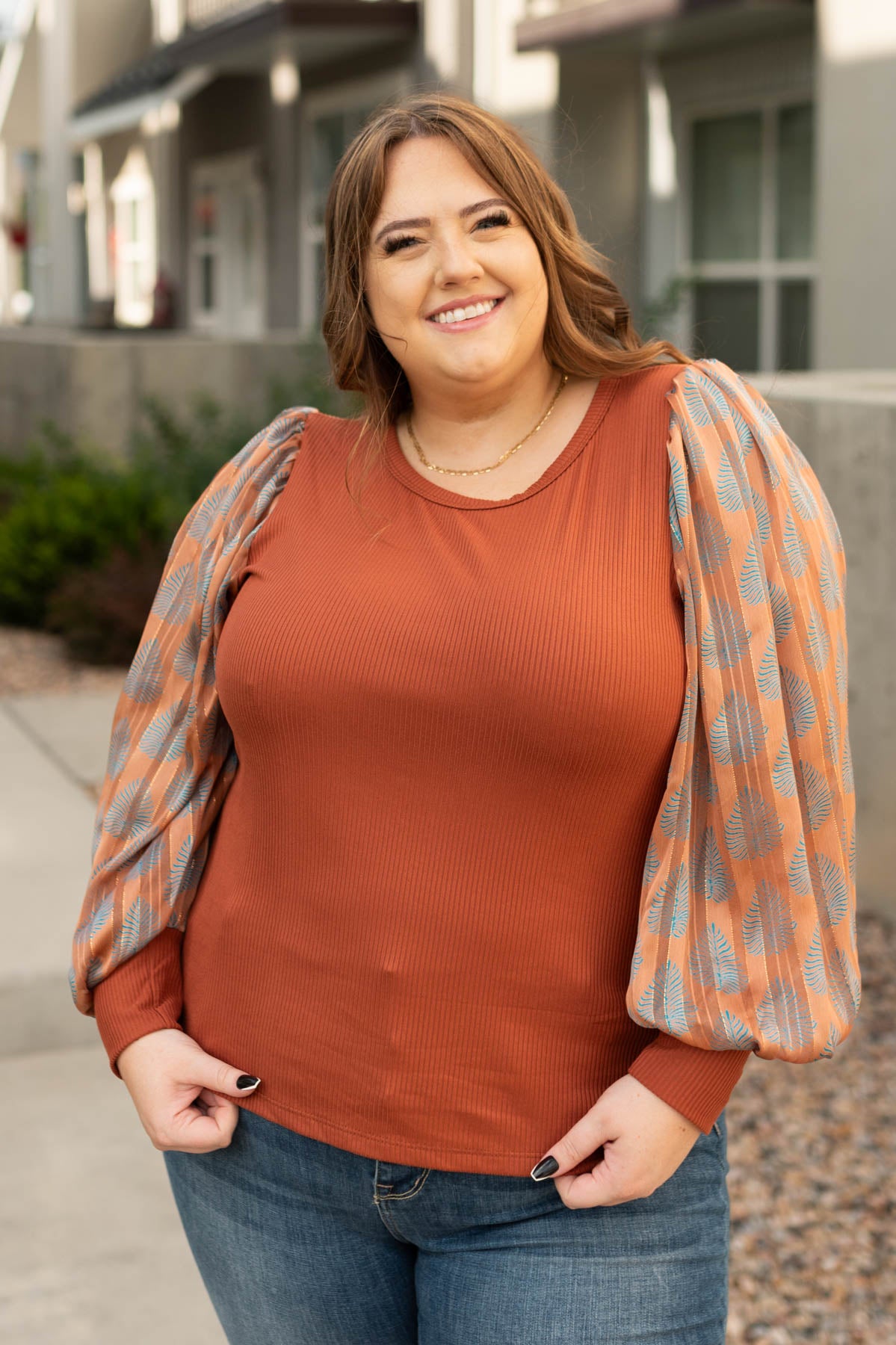 Plus size rust top with sheer pattern sleeves