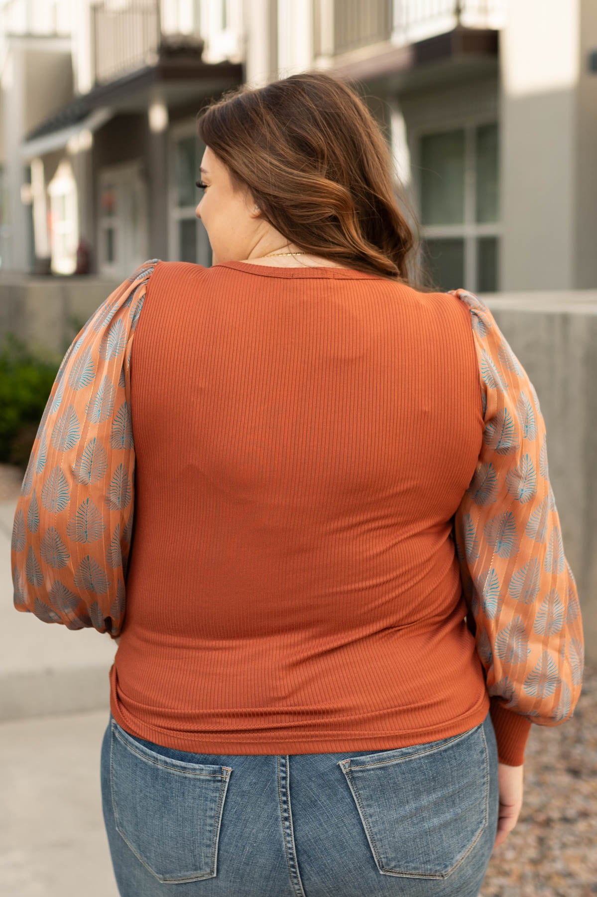 Back view of a plus size rust top