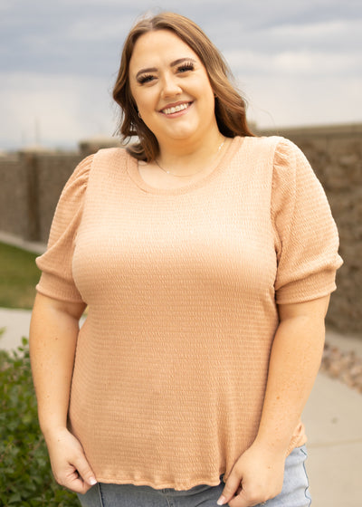 Front view of a plus size almond top