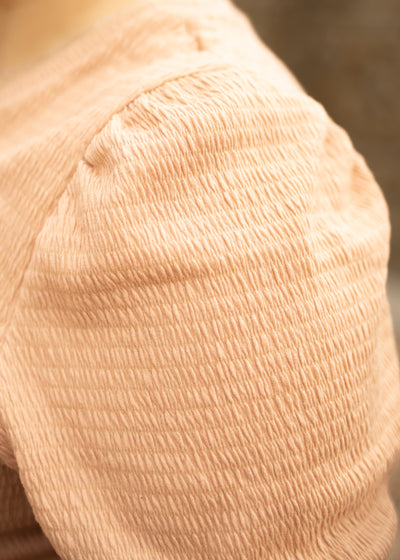 The fabric texture of a plus size almond top