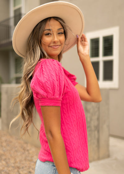 Side view of a short sleeve hot pink top