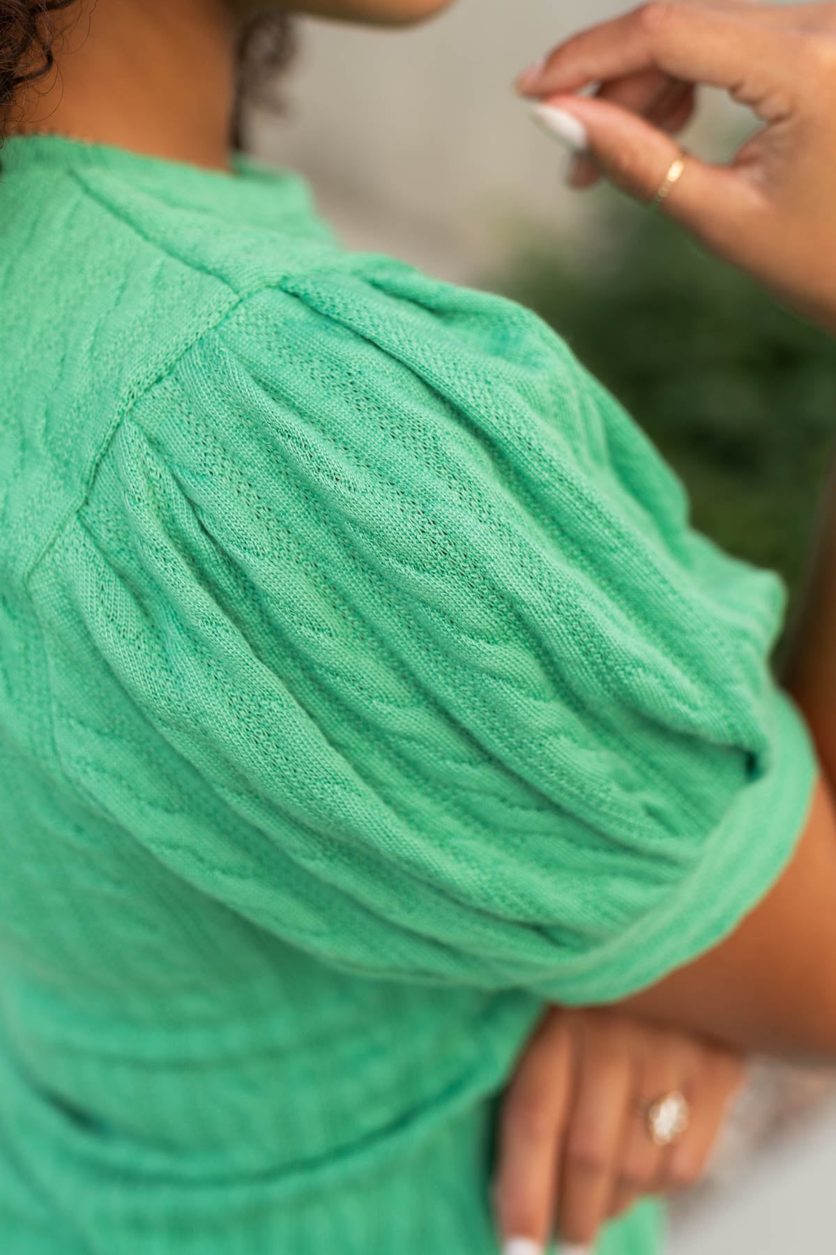 Sleeve view of a kelly green top