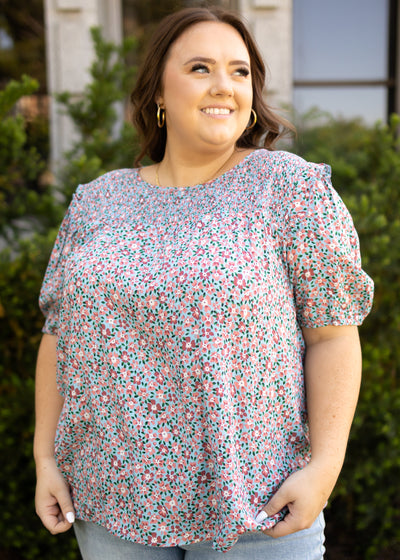 Plus size blue floral top with short sleeves and smocking at the neck