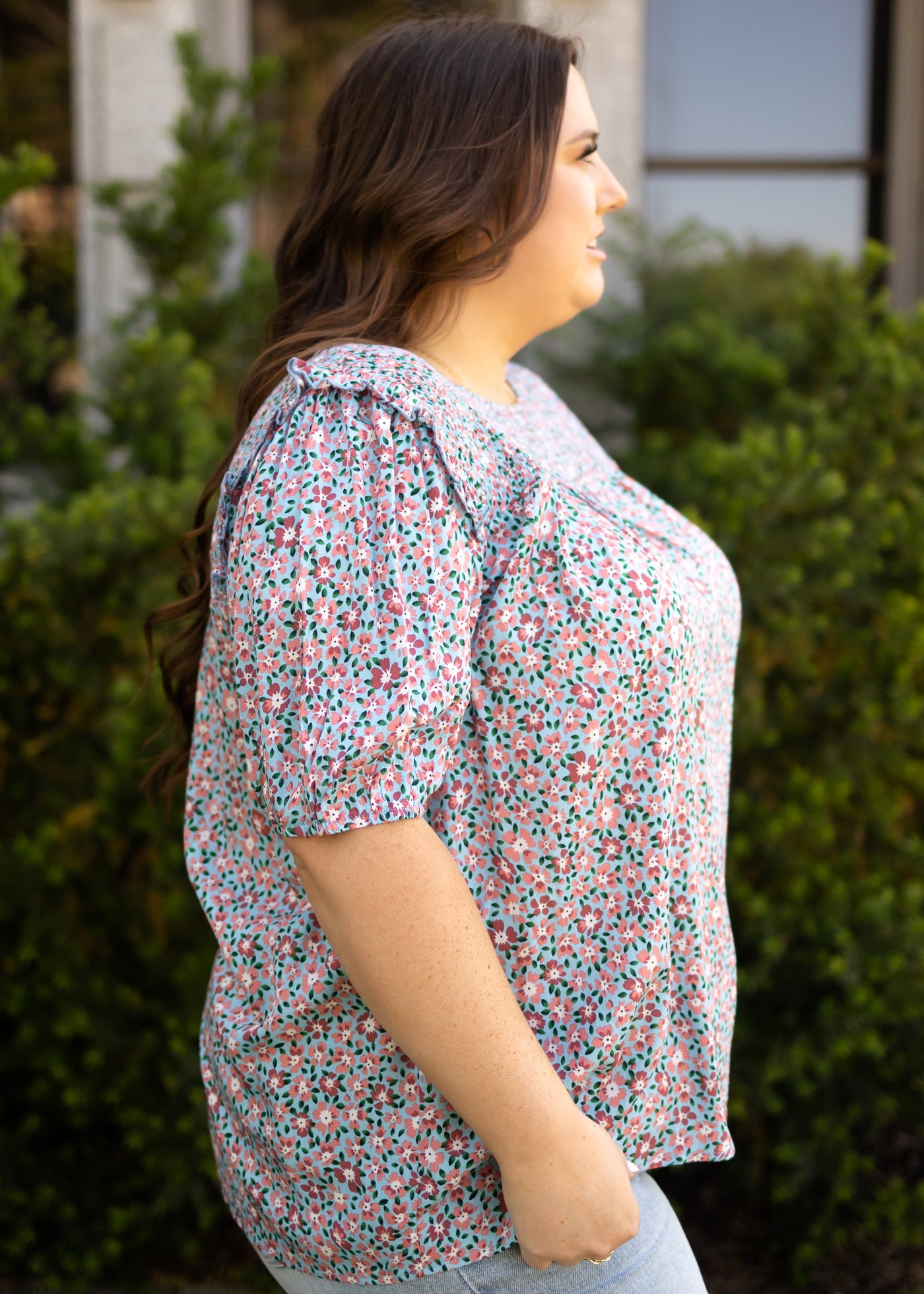 Side view of a short sleeve plus size top with ruffle at sleeve