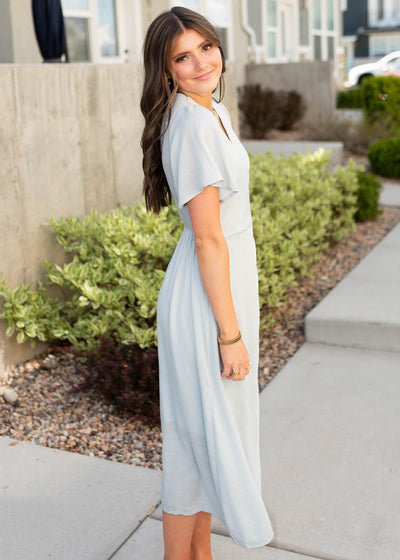 Side view of the dusty blue wrap dress