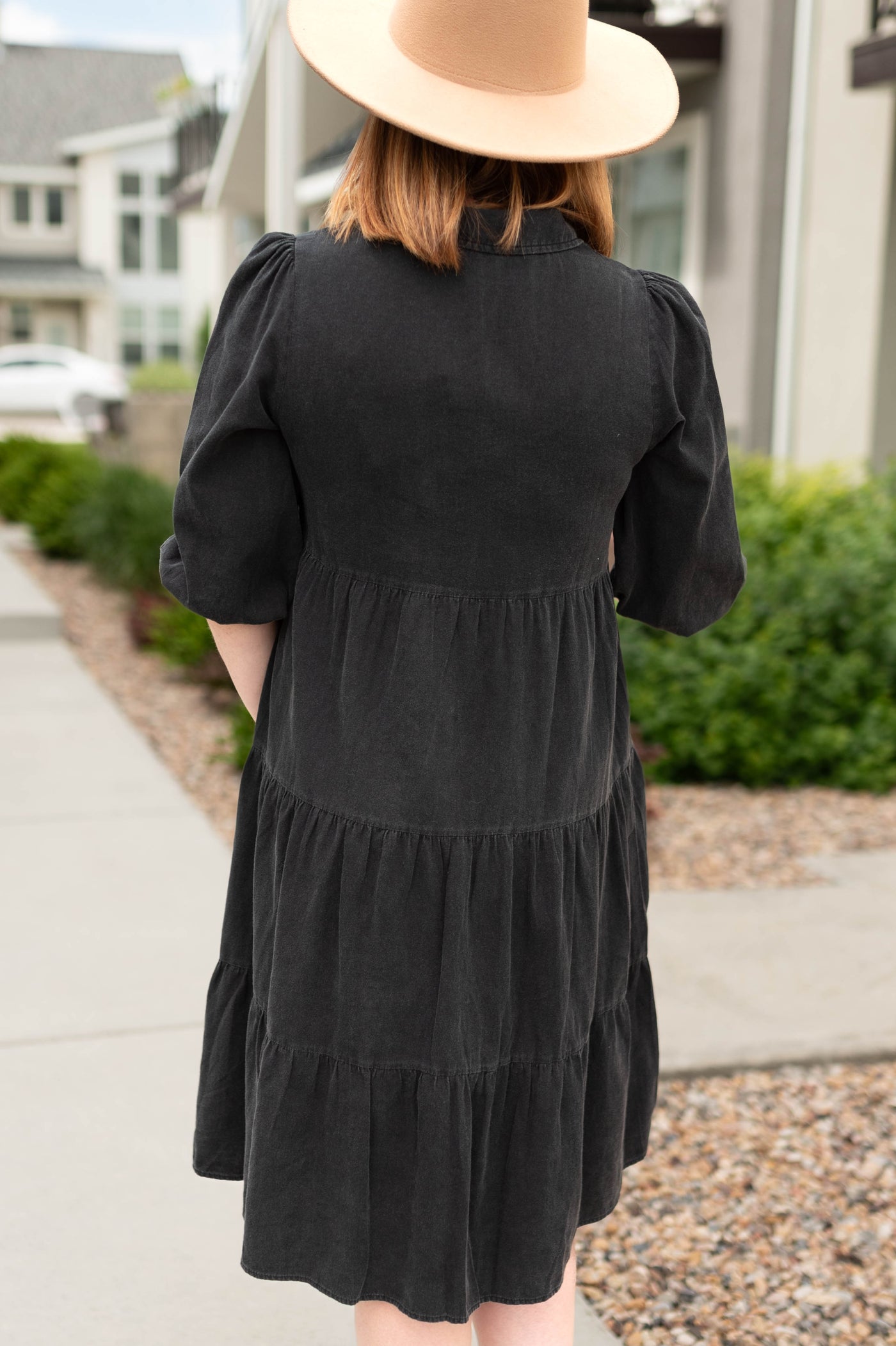 Back view of a black dress with a collar