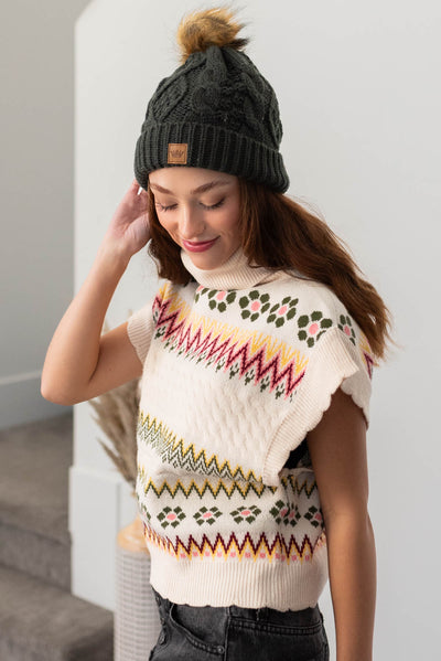 Side view of a ivory turtle neck sweater vest