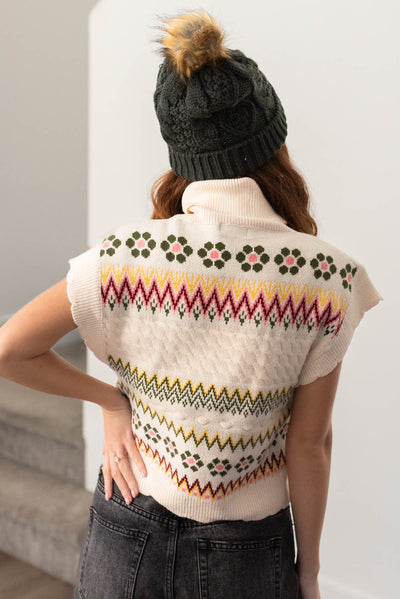 Back view of a ivory turtle neck sweater vest
