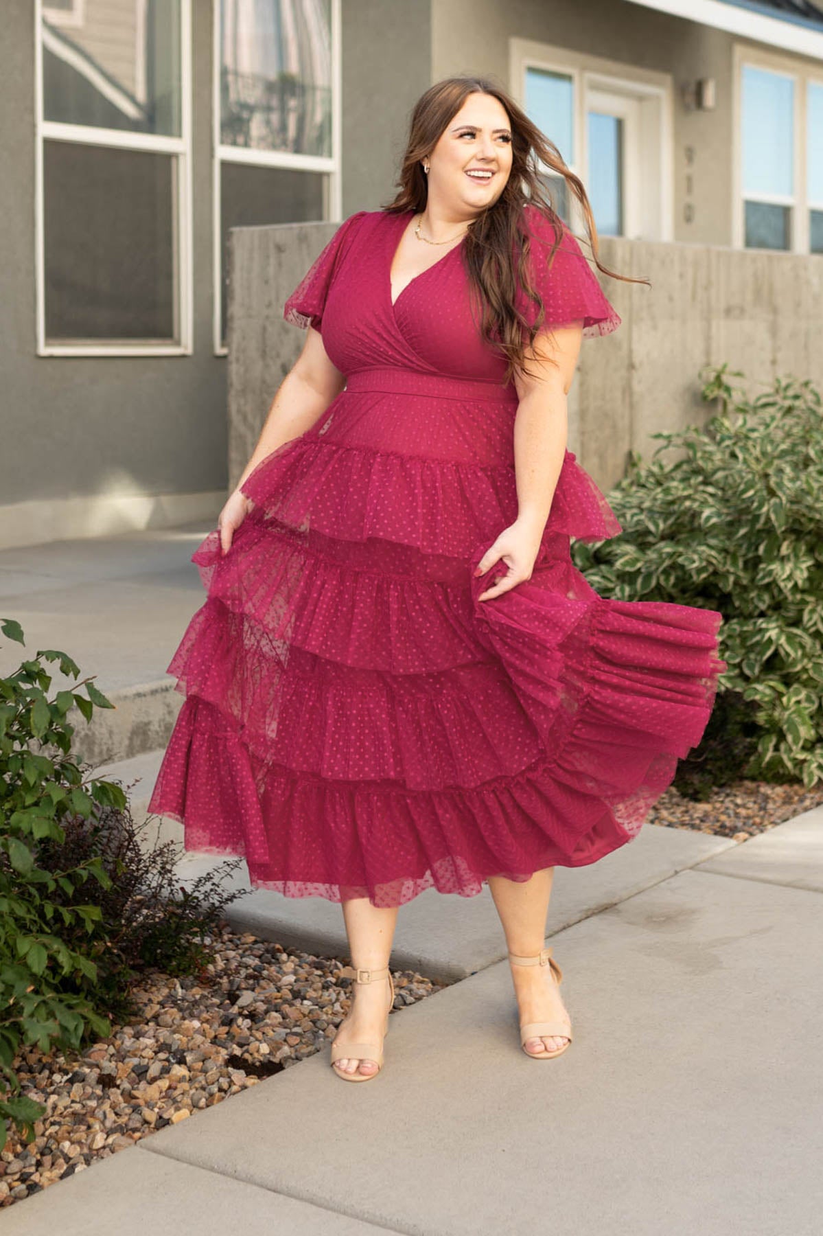 Plus size magenta dress with a ruffle skirt and polka dot pattern on the tulle 