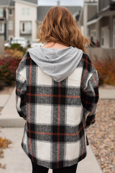 Back view of a black plaid shacket with a hood