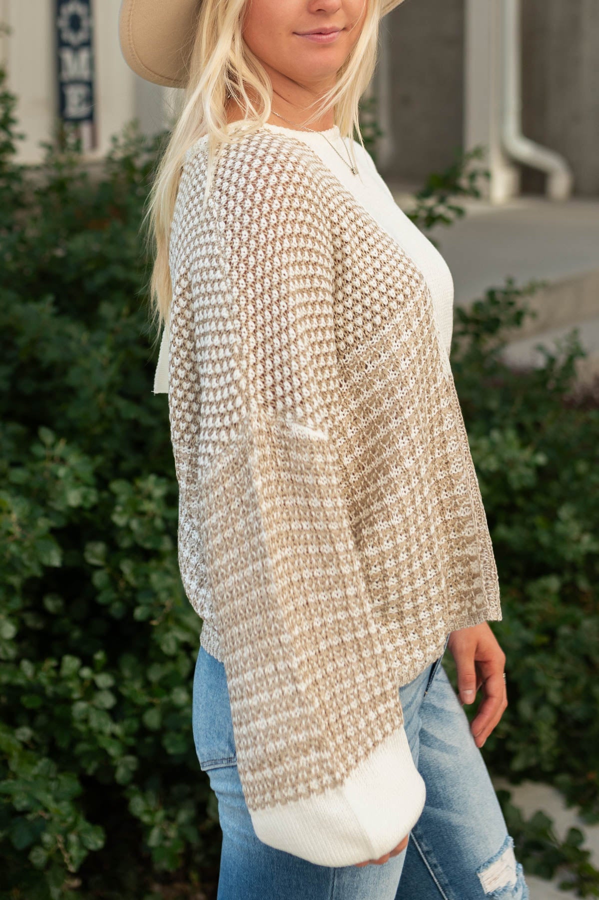Side view of a taupe sweater