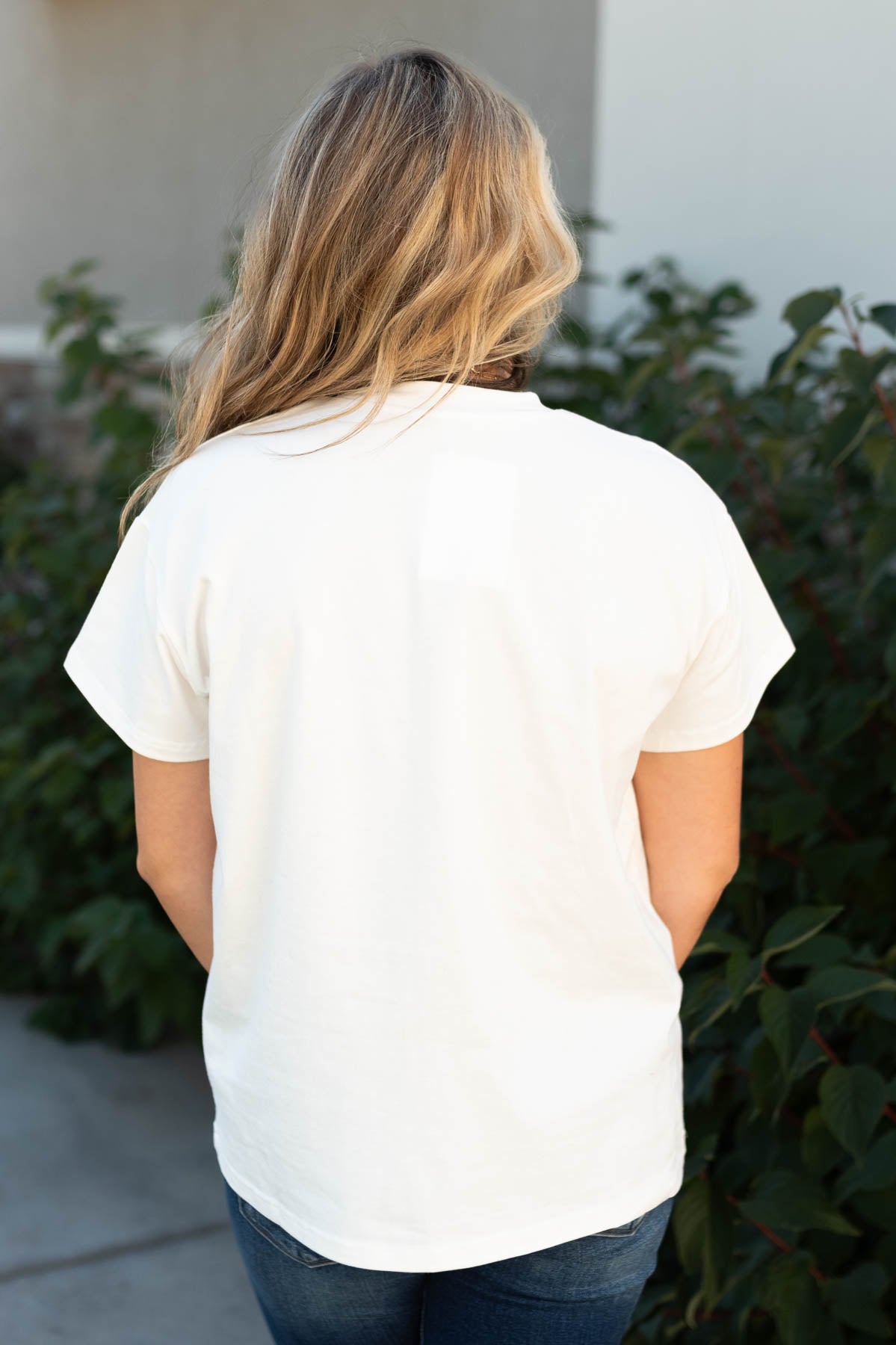 Back view of the stay wild and free ivory tee