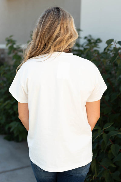 Back view of the stay wild and free ivory tee