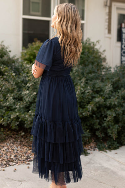 Side view of a short sleeve navy tiered dress