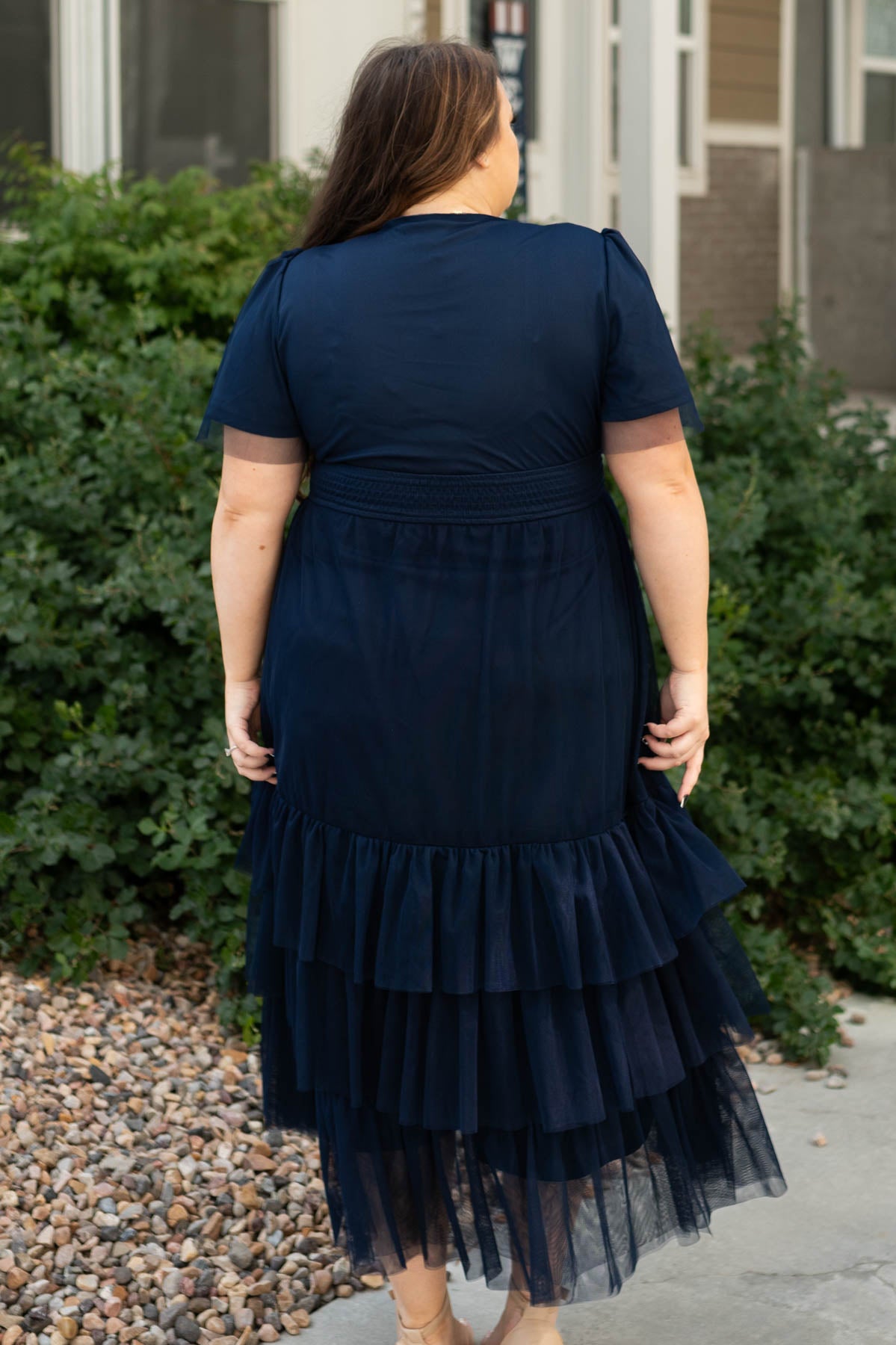 Back view of a navy tiered dress plus size