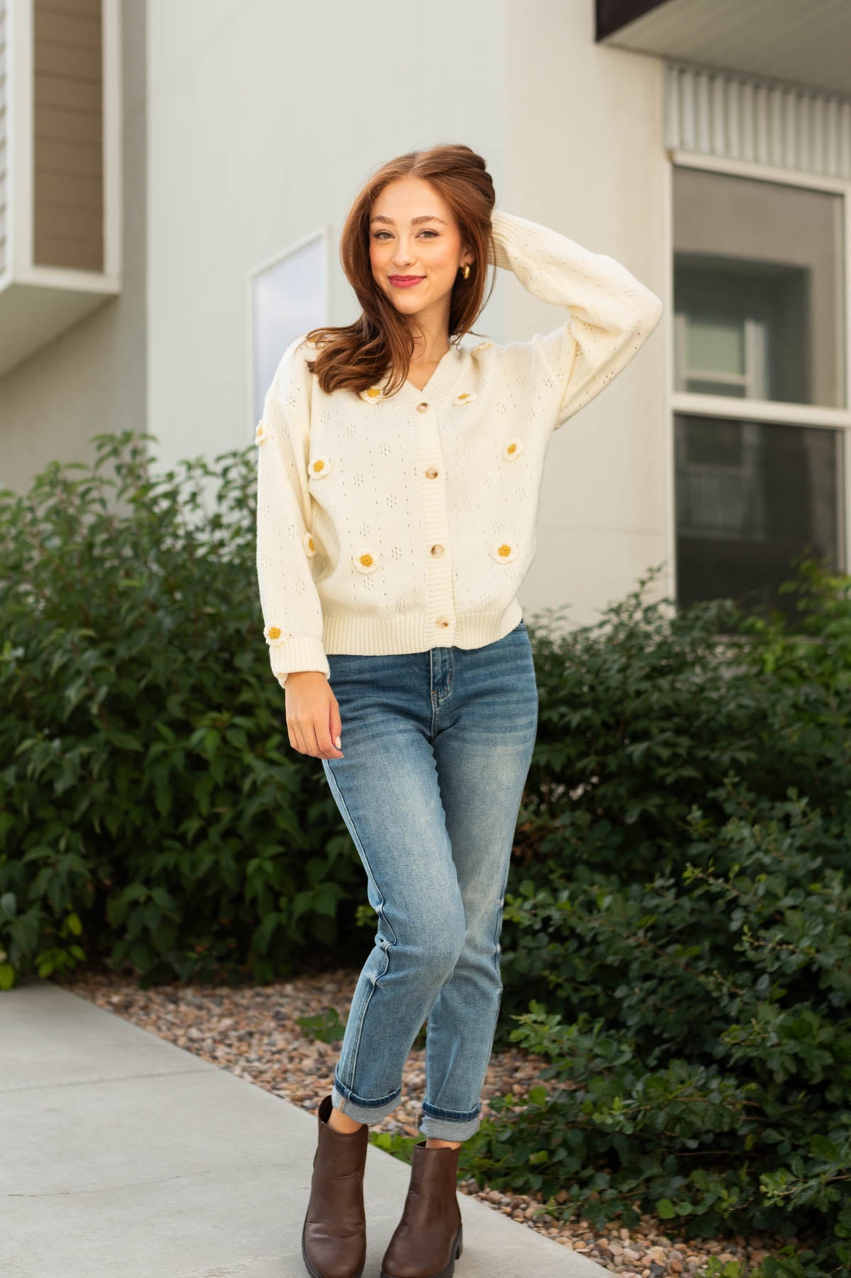 Long sleeve button up ivory cardigan with knitted daisies
