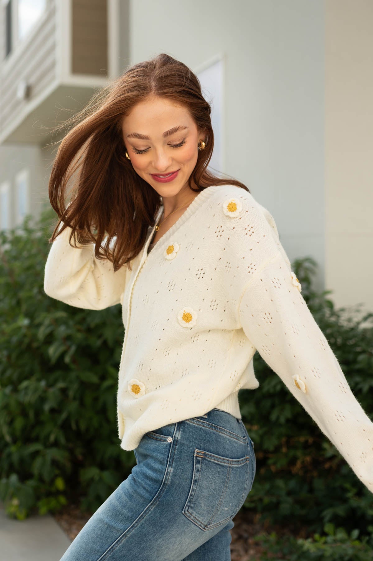 Side view of a long sleeve ivory cardigan