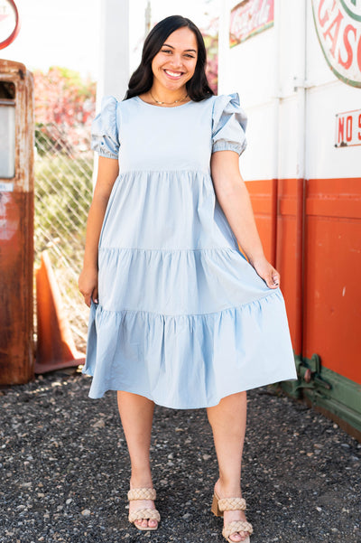 Front view of a stone blue dress with tiered skirt