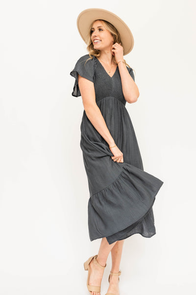 vintage blue satin dress with a V-neck and smocked bodice.
