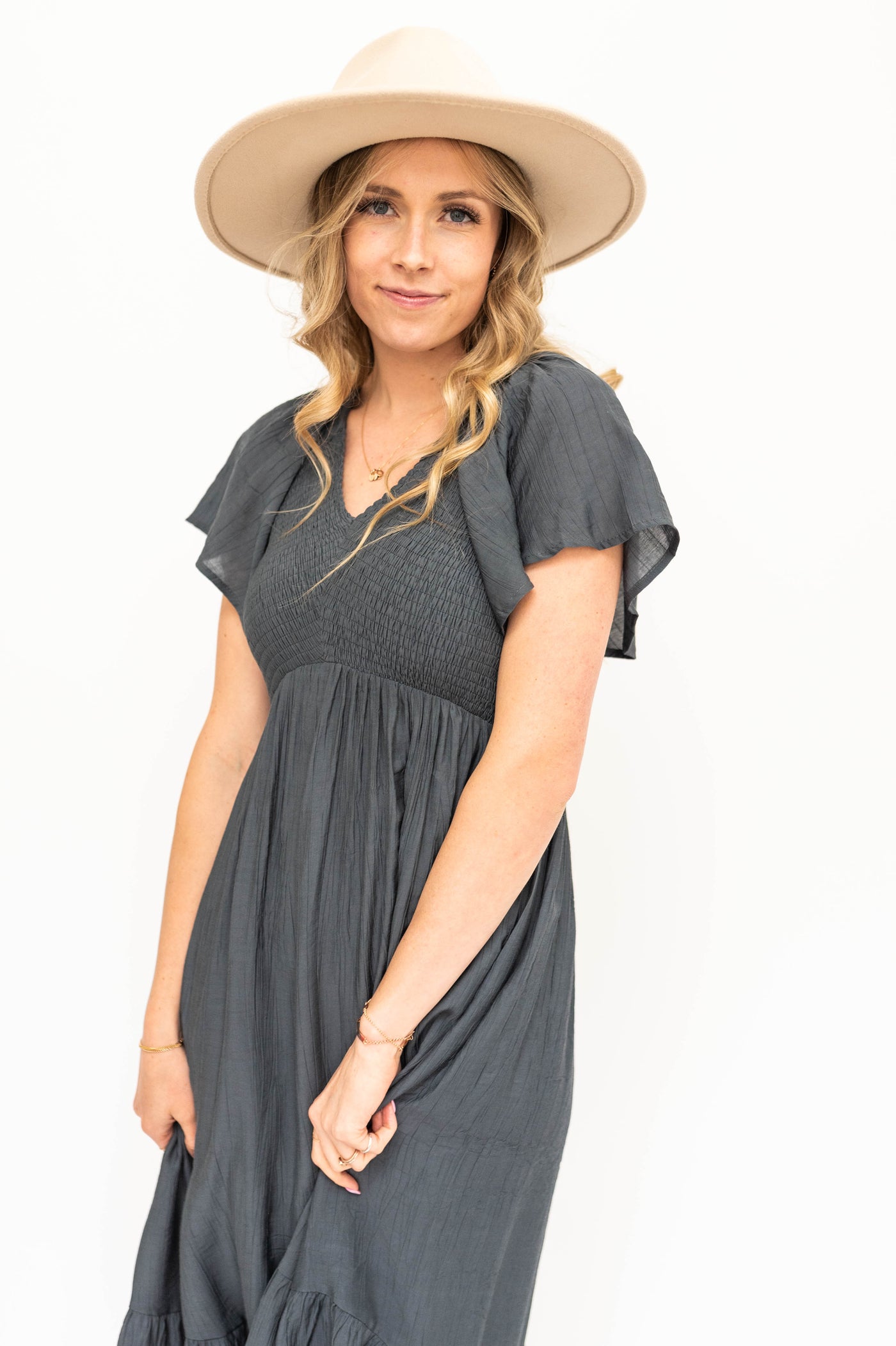 Short sleeve vintage blue dress with a V-neck and smocked bodice.