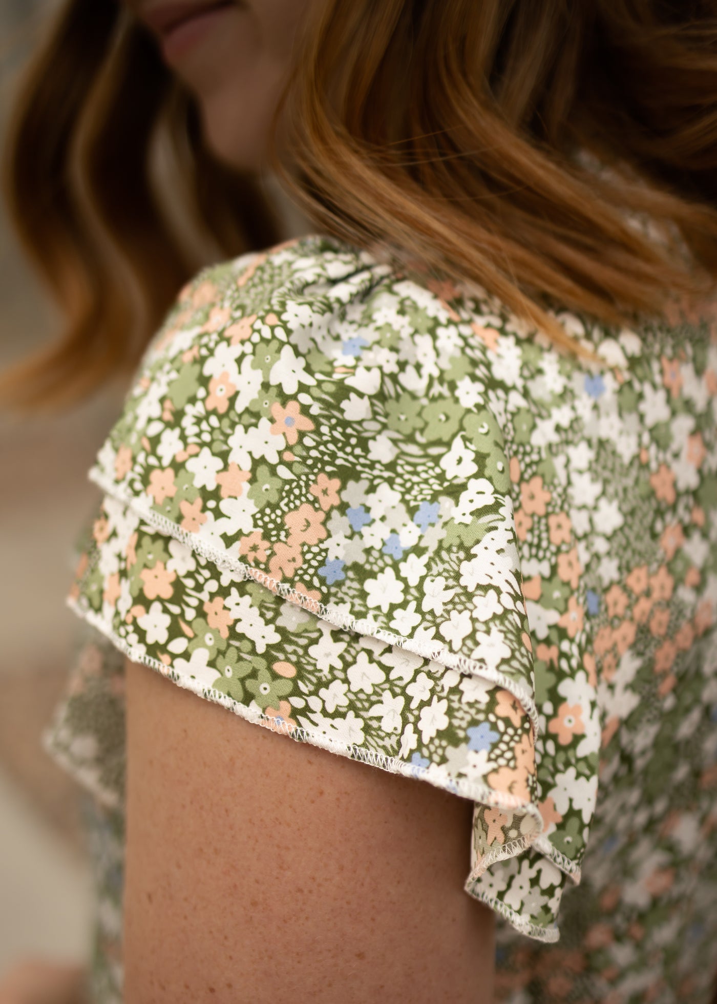 Cap sleeve of a green floral top