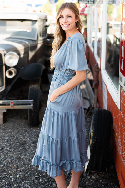 Side view of a dusty blue dress with short sleeves