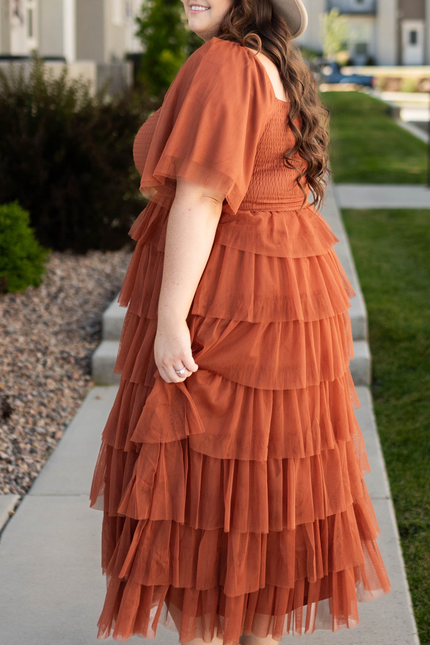 Side view of a plus size short sleeve rust dress