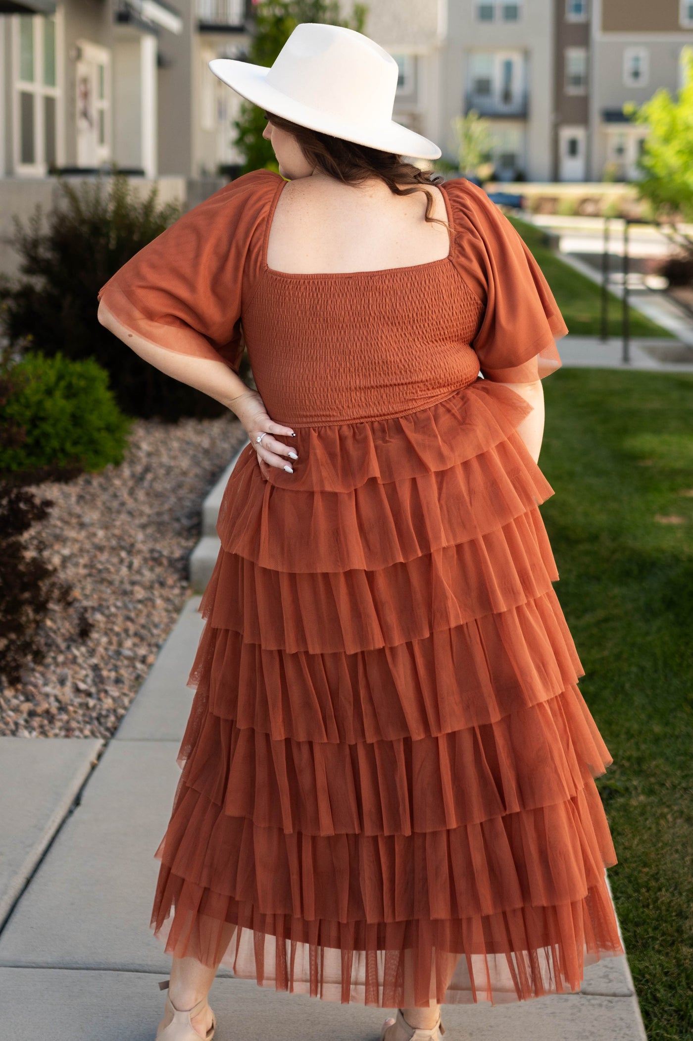 Back view of a plus size rust dress