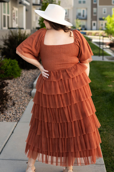 Back view of a plus size rust dress