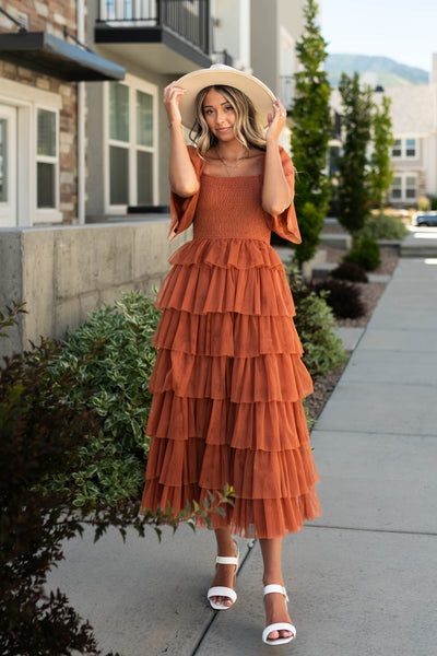Rust dress with tulle ruffle skirt and smocked bodice