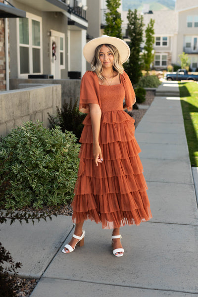 Short sleeve rust dress with ruffle skirt and smocked bodice